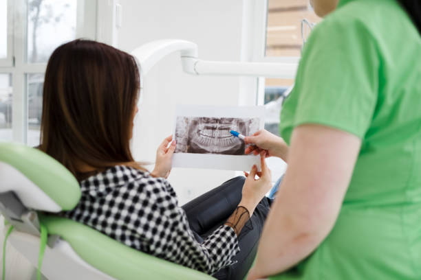 a dentist explaining the dental x-ray to a patient