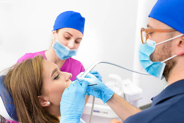 dental professionals performing a dental treatment on a patient