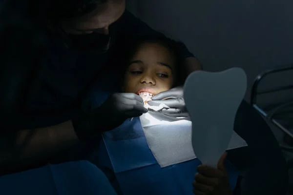 a kid receiving a dental treatment