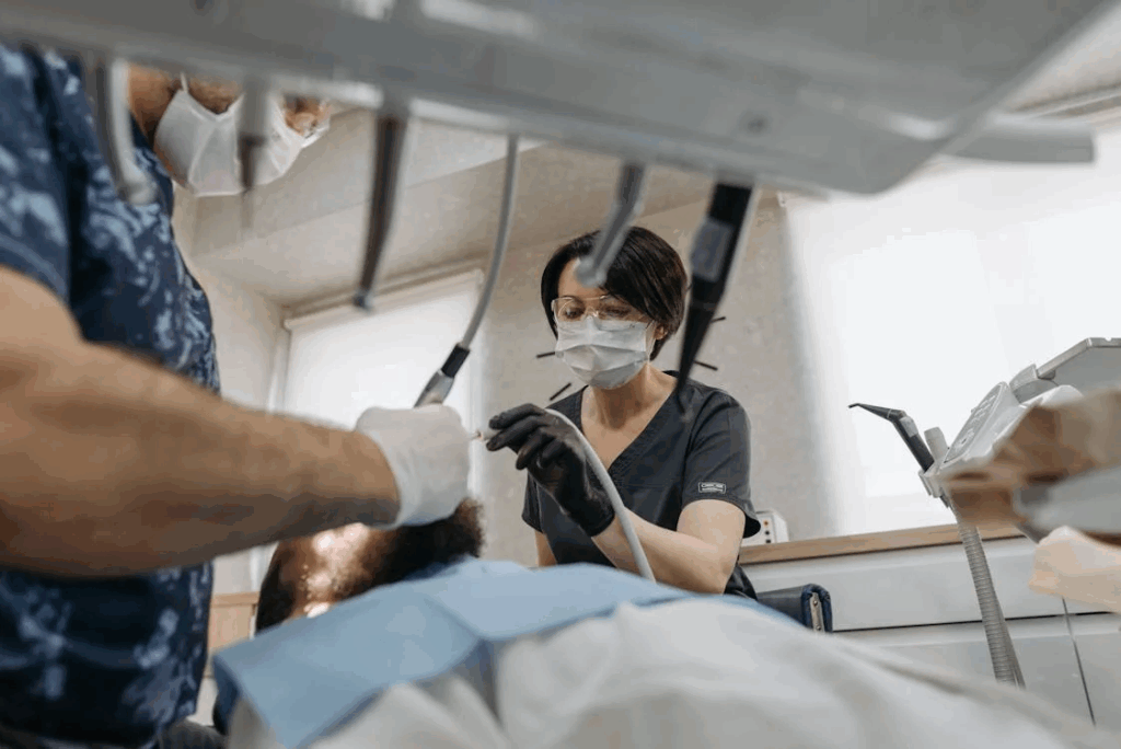 dental professionals performing dental cleaning on a patient