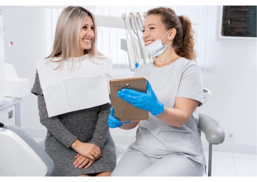 Dentist discussing dental implant treatment options with a smiling patient